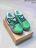 Pair of green On Cloudmonster 3 Hyper sneakers displayed on a shoebox, showing black laces and gray soles.