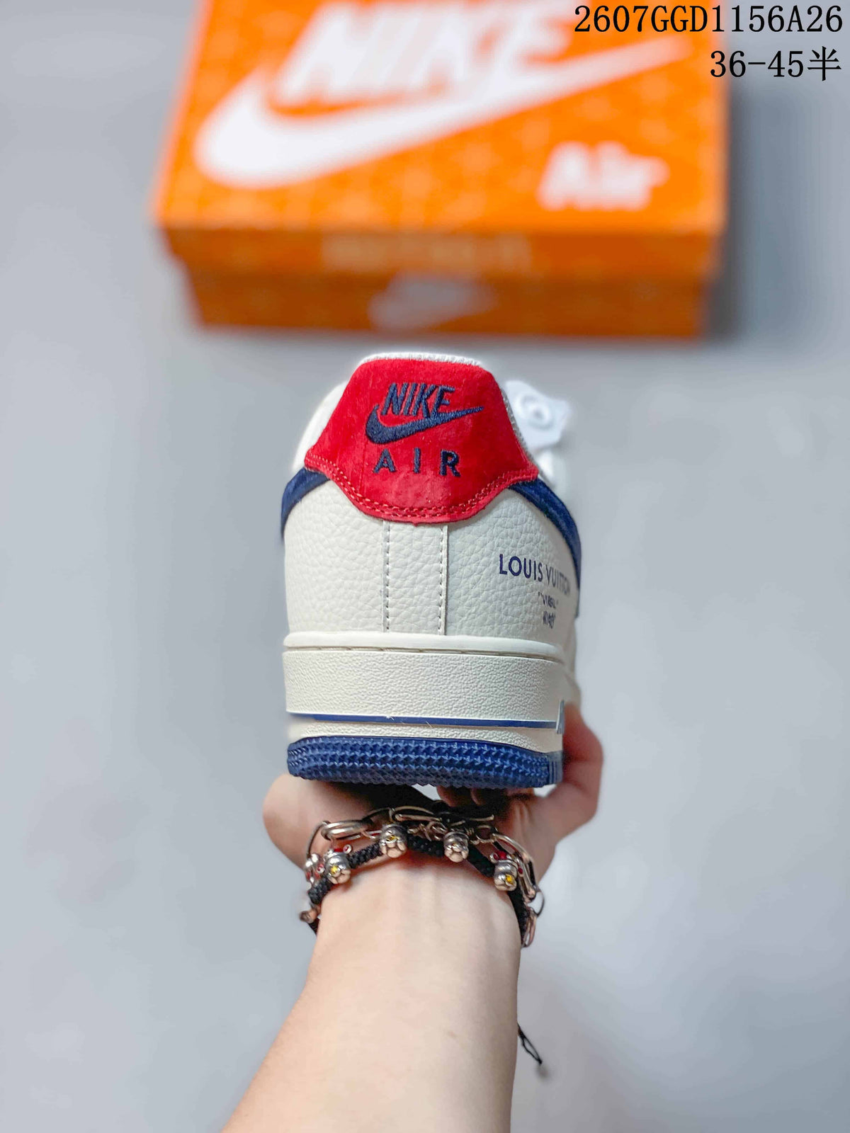 Rear view showing the red heel tab, white upper, blue outsole, and decorative side markings.