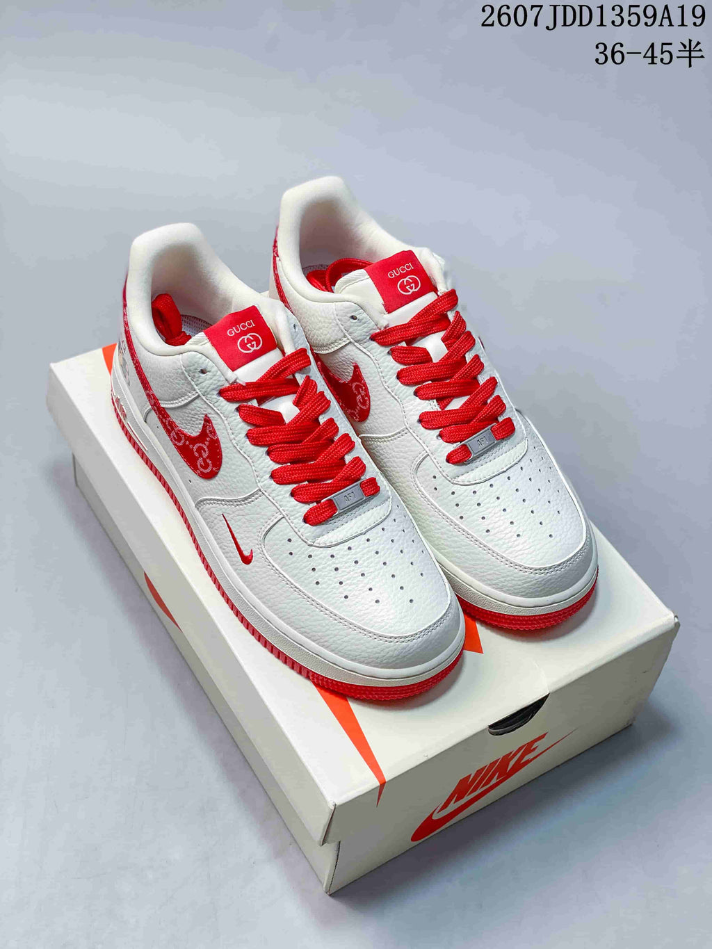 Pair of white and red low-top sneakers displayed on a Nike shoebox, with the style code and size range visible above.