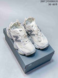 Pair of white and light gray New Balance 9060 sneakers displayed on a shoebox, with style code 2607JVD308A18 and size range text visible above.