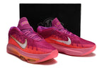 Pink and purple Nike GT Hustle 3 pair displayed in front of a box.
