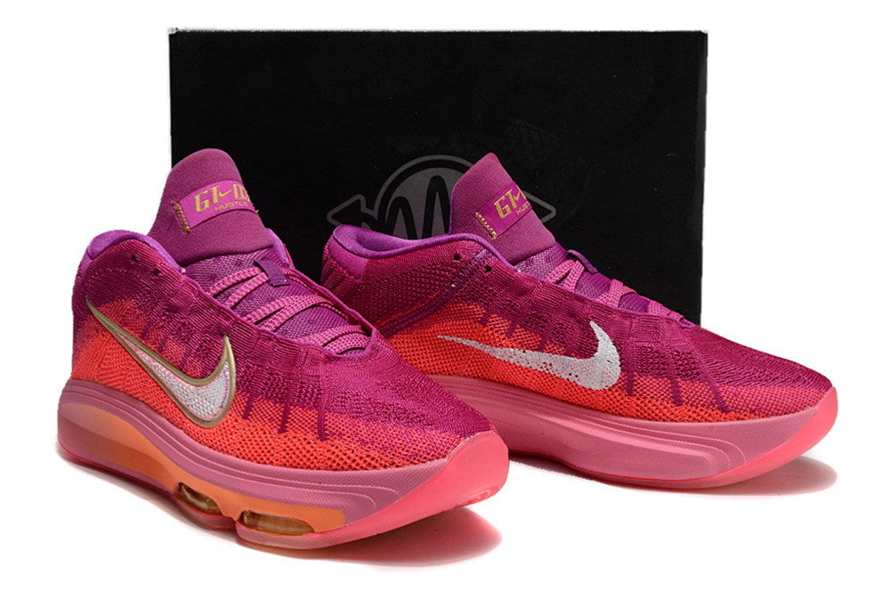 Pink and purple Nike GT Hustle 3 pair displayed in front of a box.