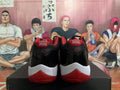 Rear view of black and red Air Jordan 11 sneakers with white midsoles.
