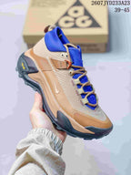 Side three-quarter view showing the tan and blue color blocking, Nike side branding, heel pull tab, and black outsole.