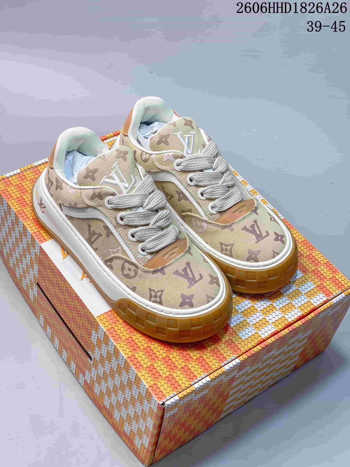 Pair of beige monogram-patterned Louis Vuitton Tilted low-top sneakers with white laces and gum-colored soles.