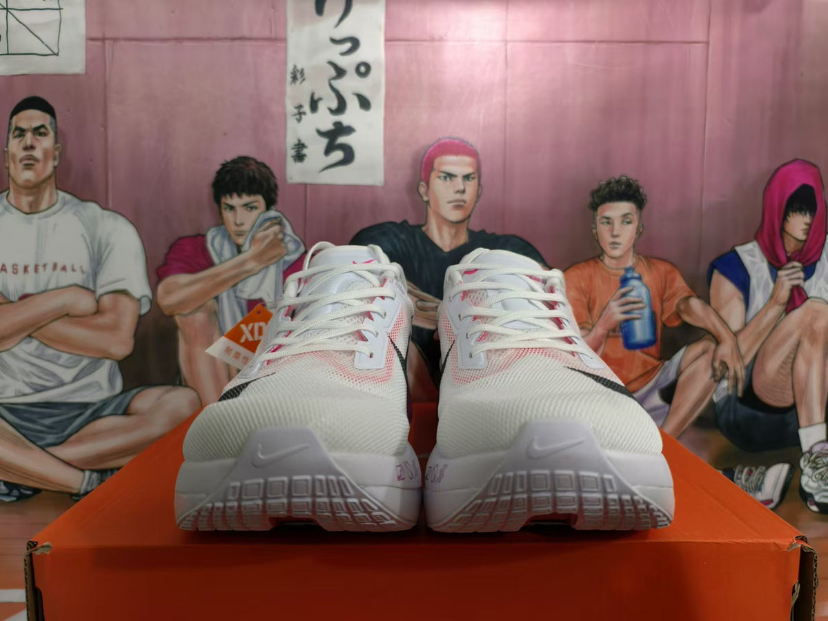 Front view of white Nike running shoes with pink accents and dark Swoosh logos