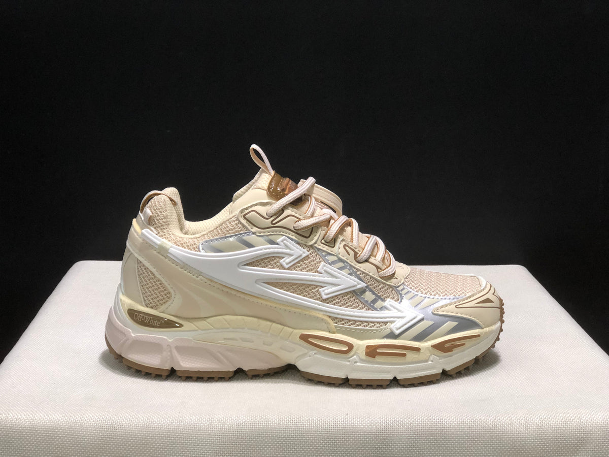 Single side profile of the cream OFF-WHITE Be Right Back sneaker against a dark background.