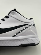 Close-up of the white side panel, black Swoosh, and heel structure