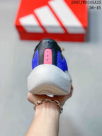 Rear view of the sneaker showing the black heel, purple side panels, pink heel detail and white sole.