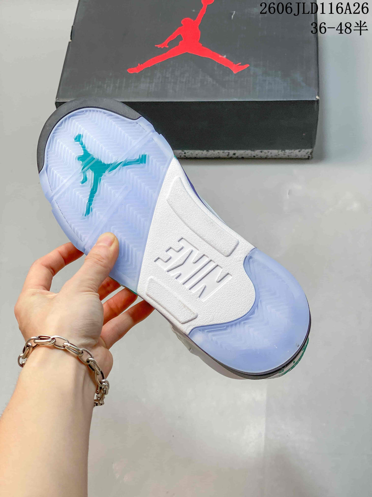 Outsole view of a Jordan sneaker with translucent-looking tread and teal Jumpman graphic