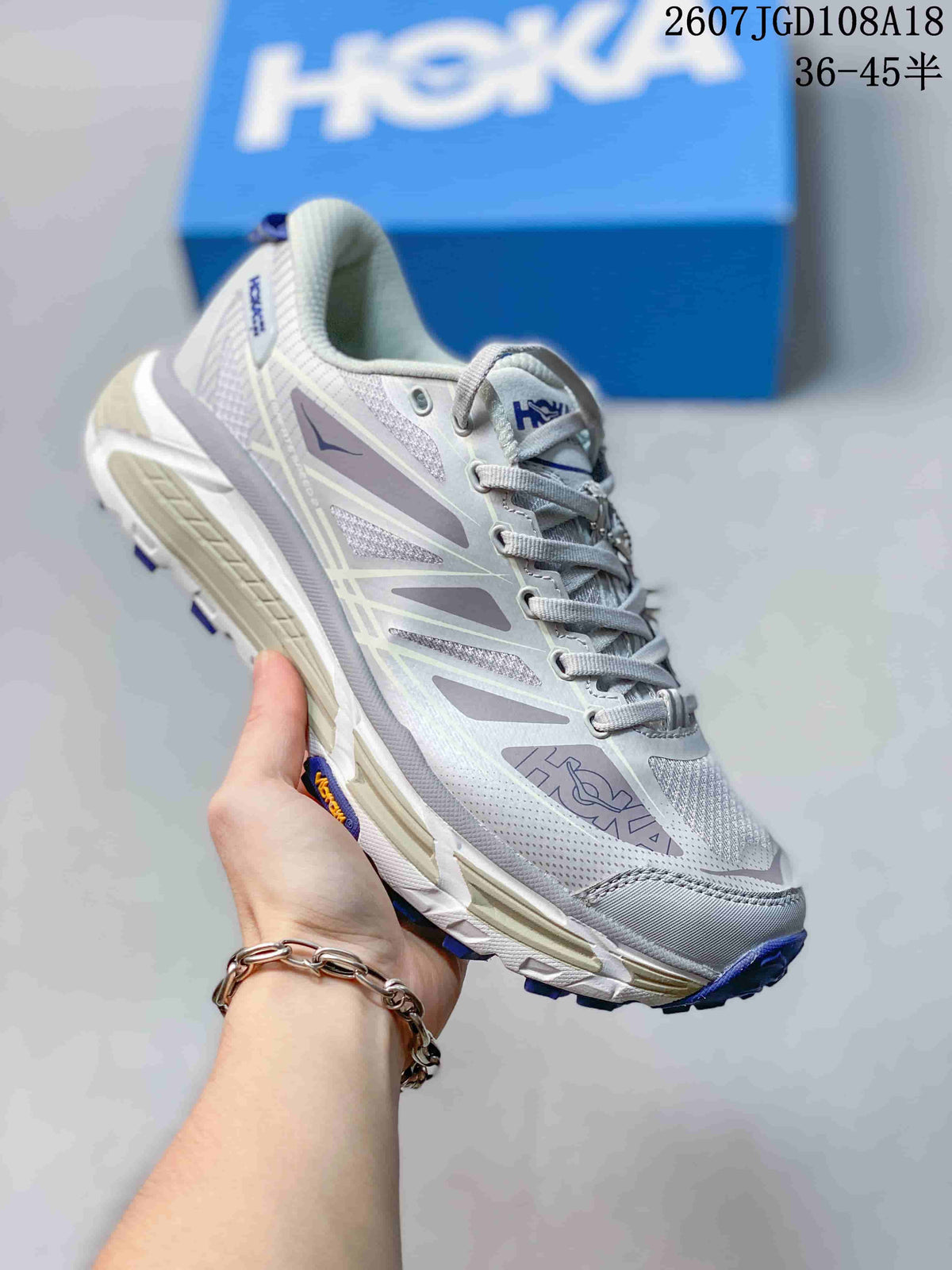 White and light gray HOKA Mafate Speed 2 sneaker with blue outsole details.