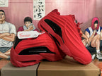 Pair of red Nike basketball shoes with sculpted side panels and black accents