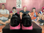 Rear view of black basketball shoes with pink marbled sole accents