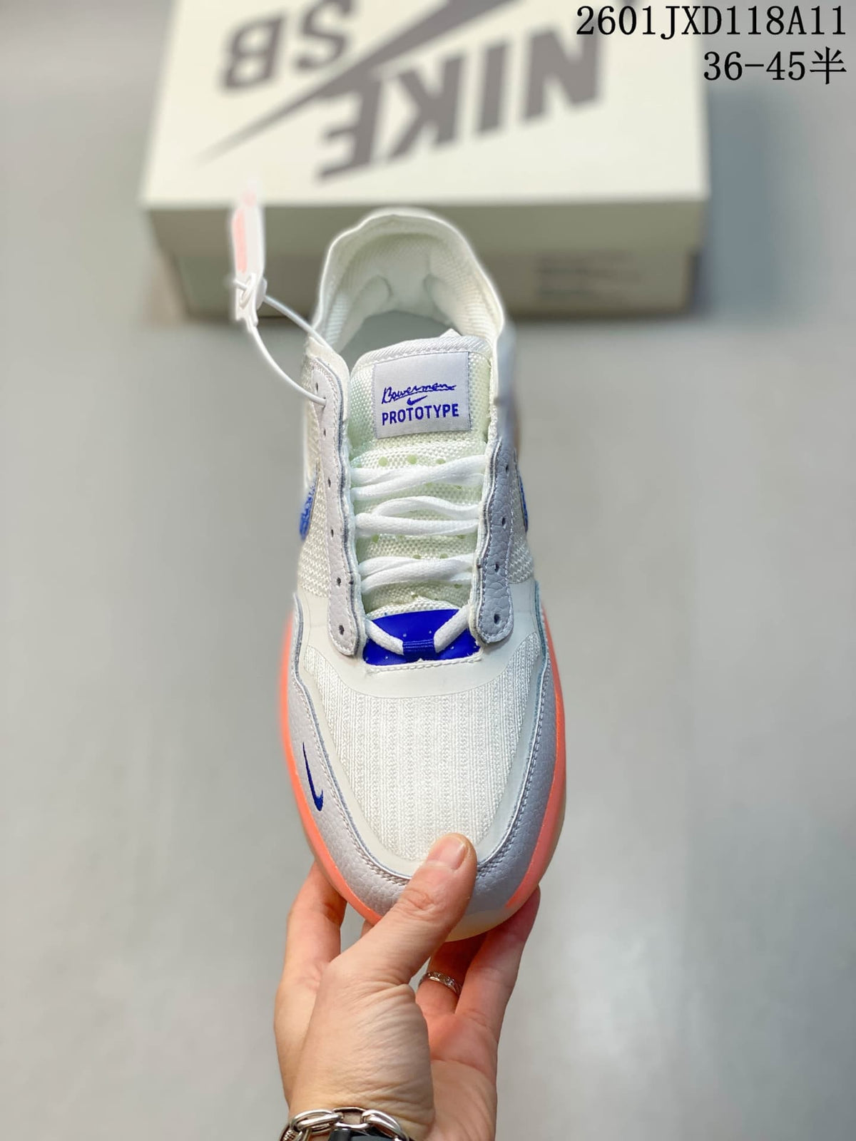 Top view showing the white textile toe box, lace system, blue tongue detail, and contrasting overlays.