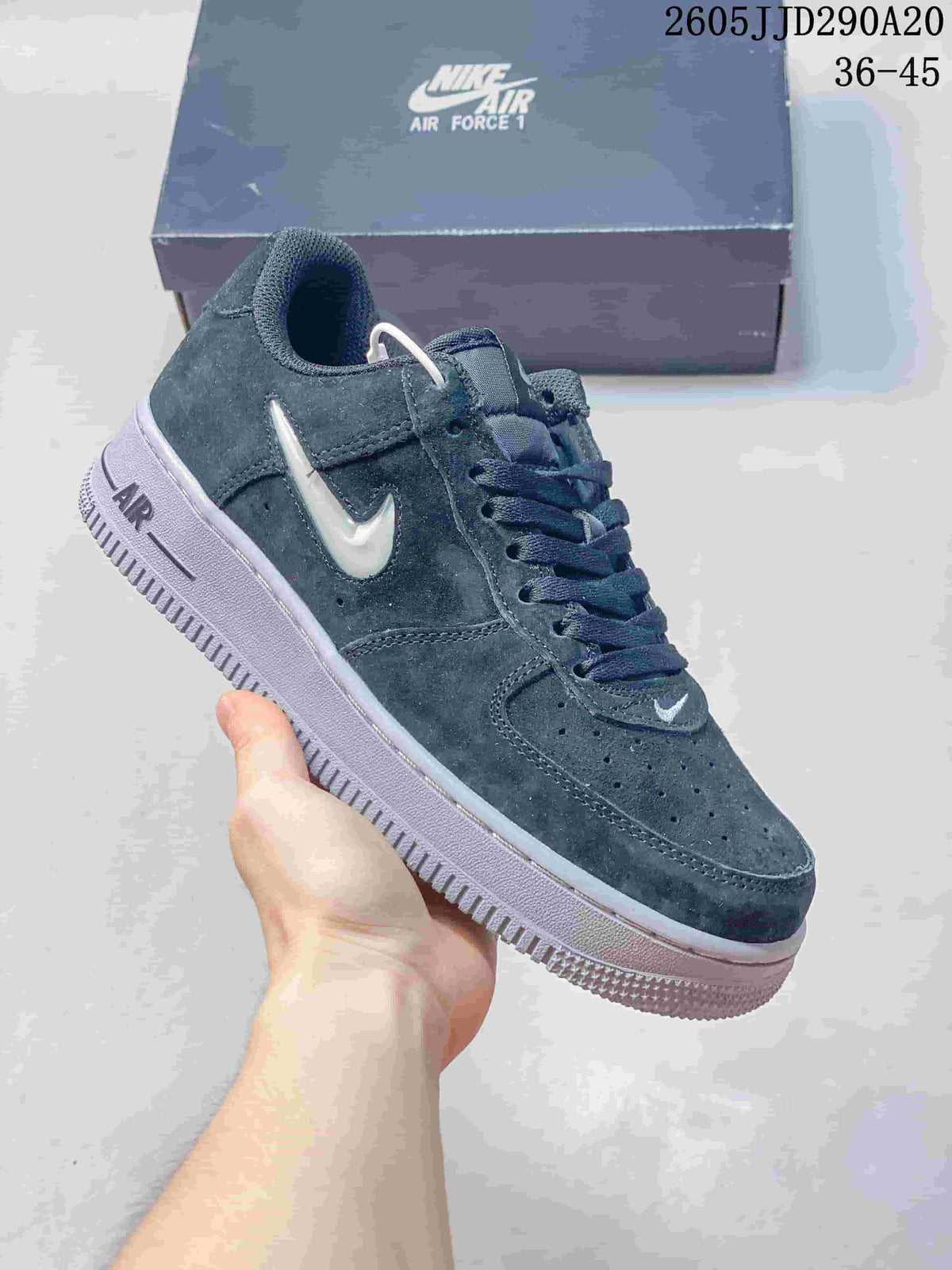 Charcoal suede-look low-top sneaker with a light-colored Swoosh