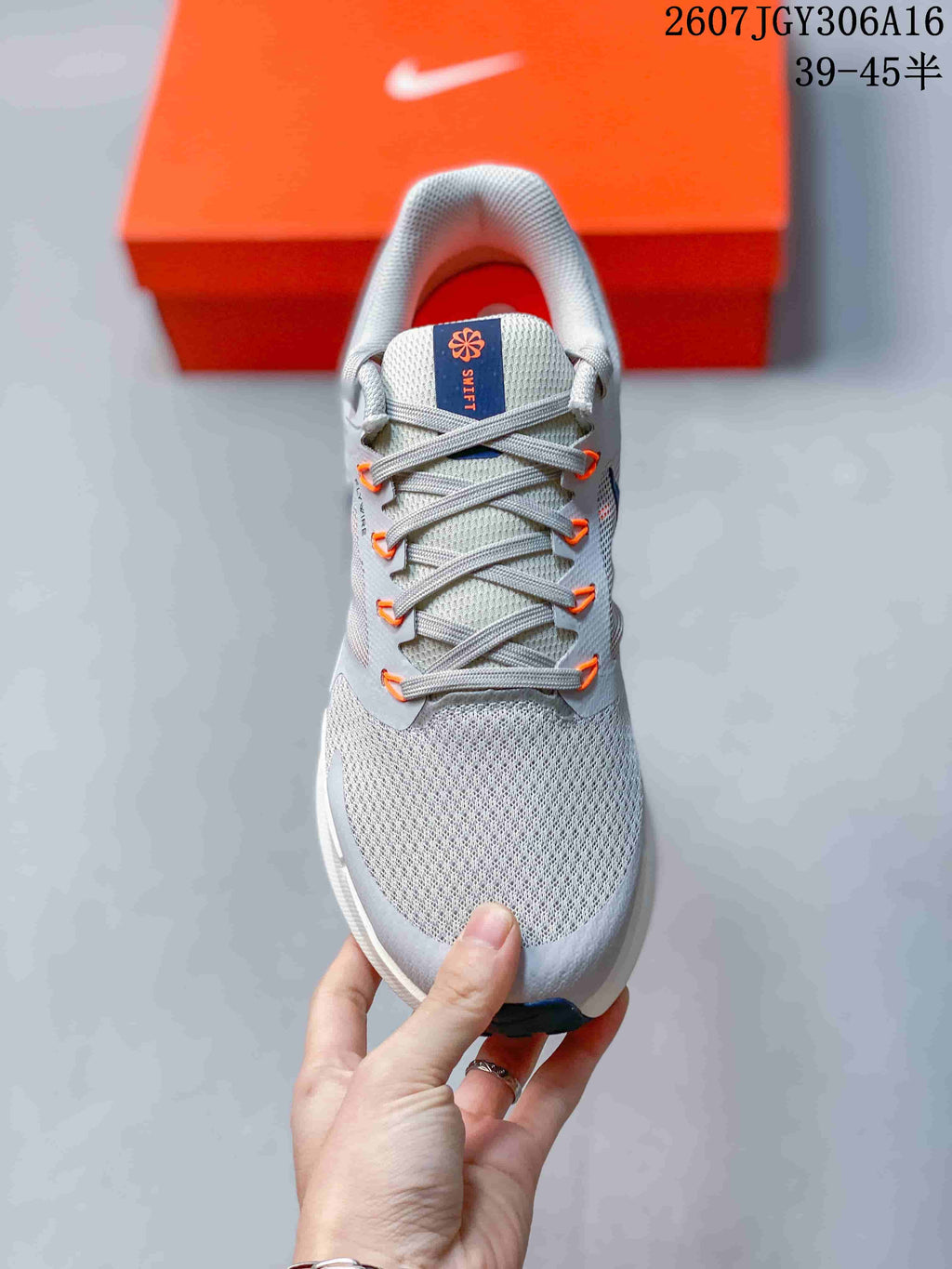 Top view showing the gray laces, orange lace loops, padded tongue and textured toe area.