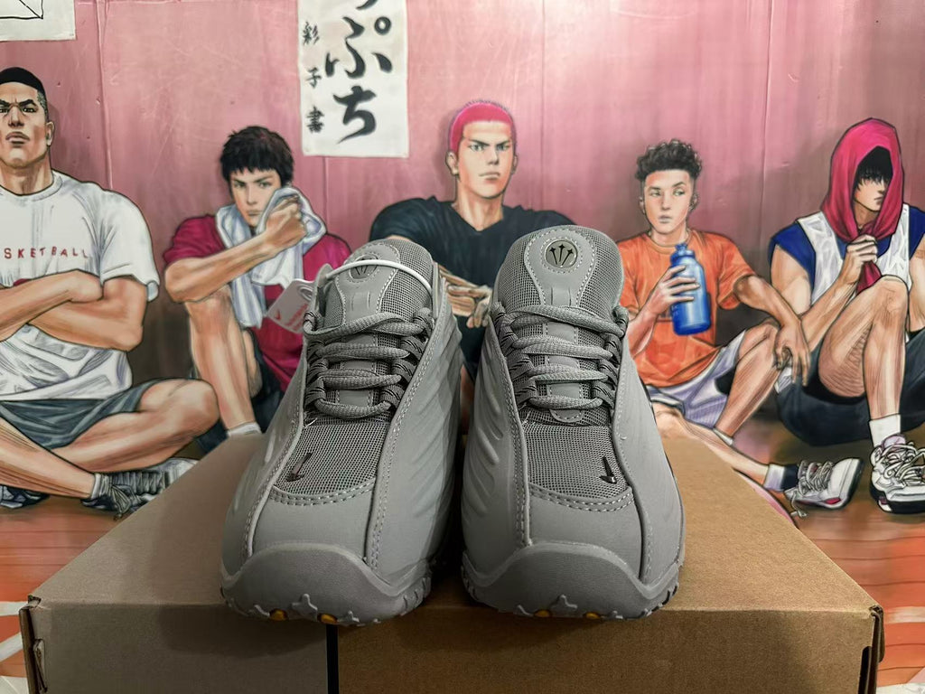 Front view of grey lace-up sneakers with mesh tongues