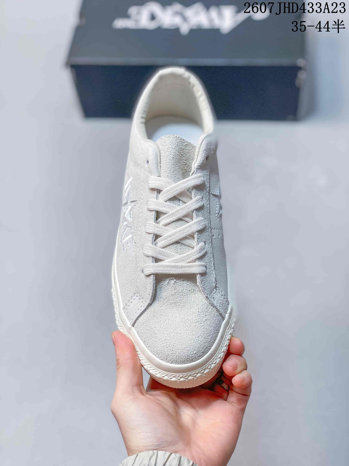 Top view of the white lace-up sneaker showing the textured upper, tongue, eyelets, and rounded toe.