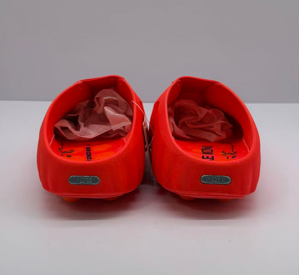 Rear view of the pair showing heel badges and printed footbeds.