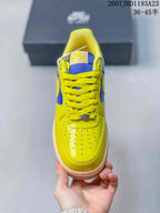 Top view of the sneaker showing the perforated yellow toe box, yellow laces, and blue tongue.