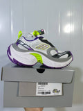 Skechers 9157 sneaker shown from the side above its box, with a white, grey, purple and lime color scheme; the box label shows size EU 40.