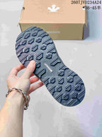 Close view of the patterned rubber outsole with raised geometric tread and DESCENTE branding.