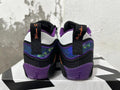 Rear view of black and purple Jordan basketball shoes with patterned heel panels and white heel details.