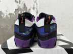 Rear view of black and purple Jordan basketball shoes with patterned heel panels and white heel details.
