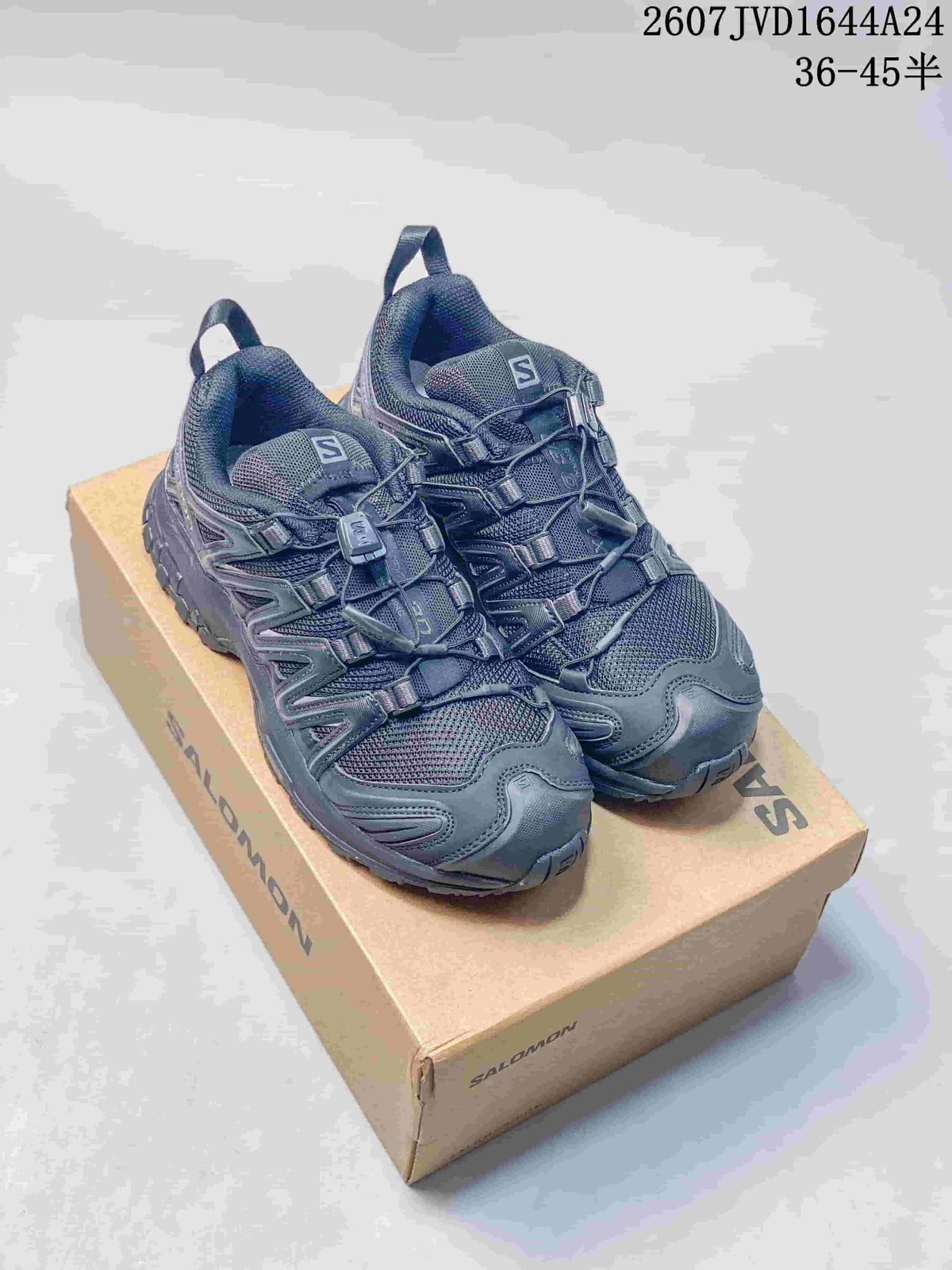 Pair of black Salomon XA Pro 3D Seasonal sneakers displayed on a Salomon shoebox.
