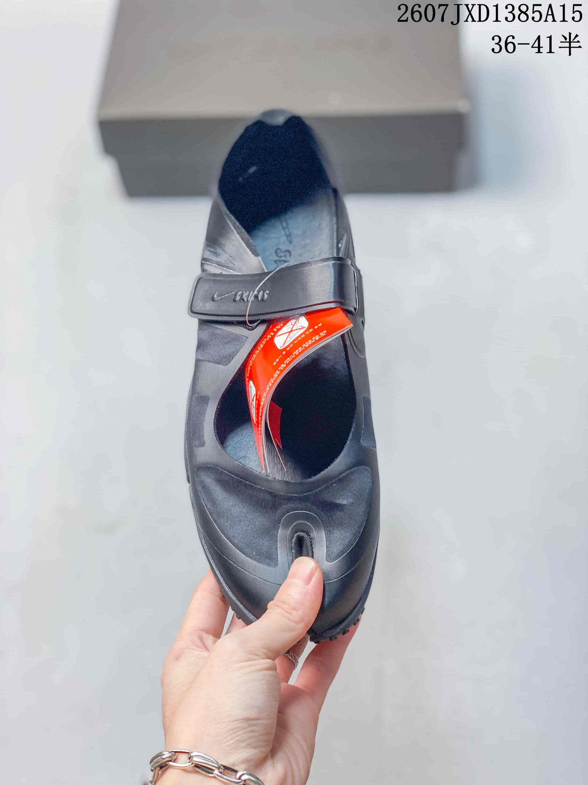 Top view of a black Nike Air Rift shoe showing the split-toe opening, strap, and red tag.