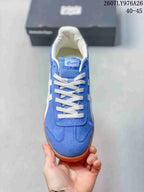 Top view of the blue sneaker showing white laces, a branded tongue label, and stitched toe detailing.