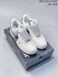 Pair of white and blue low-top sneakers displayed on a shoebox, with the style code and size range overlaid at the top.