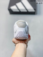 Rear view showing the padded heel area and outsole pattern of the white sneaker.
