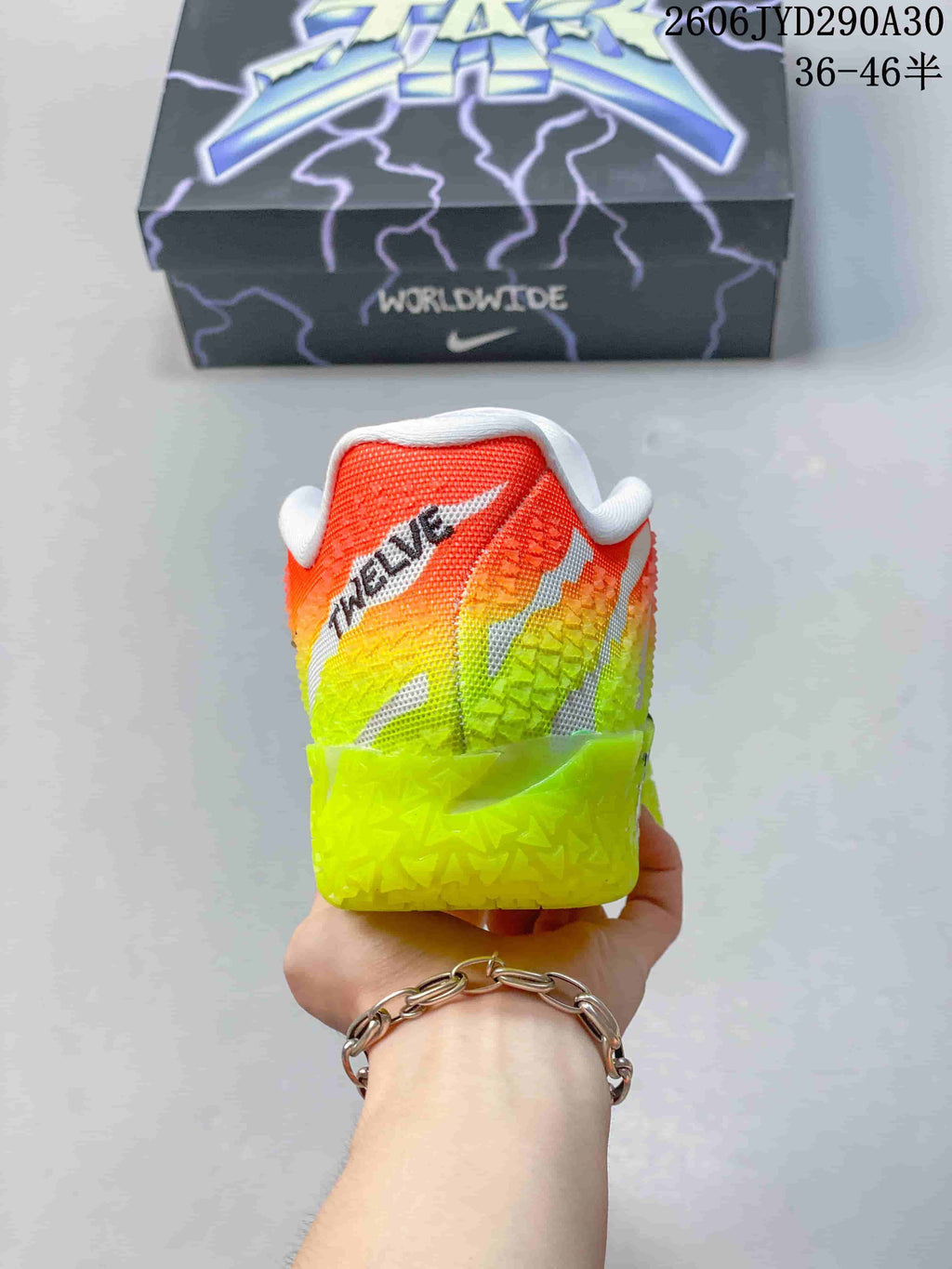 Rear view of a Nike Ja 3 basketball shoe with a neon yellow, orange, and white upper.