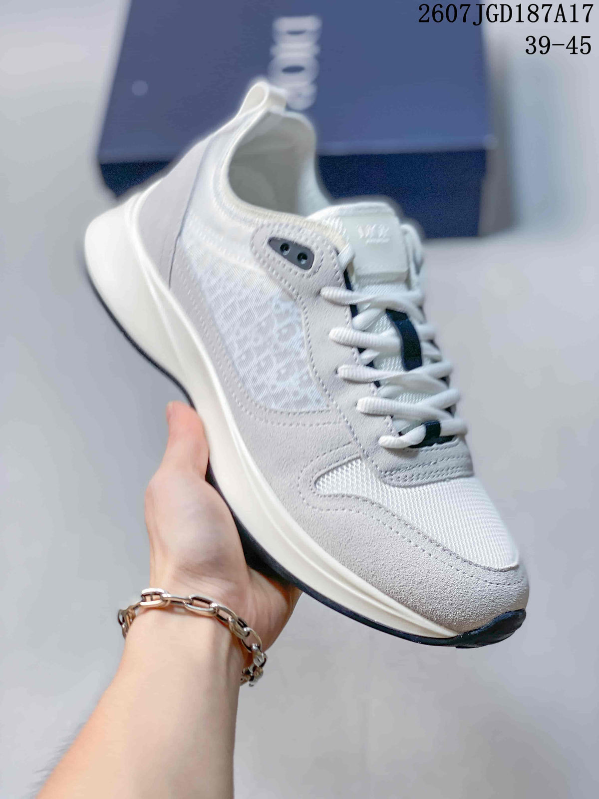 Angled side view highlighting the white and gray upper, layered construction, pull tab, and raised sole.