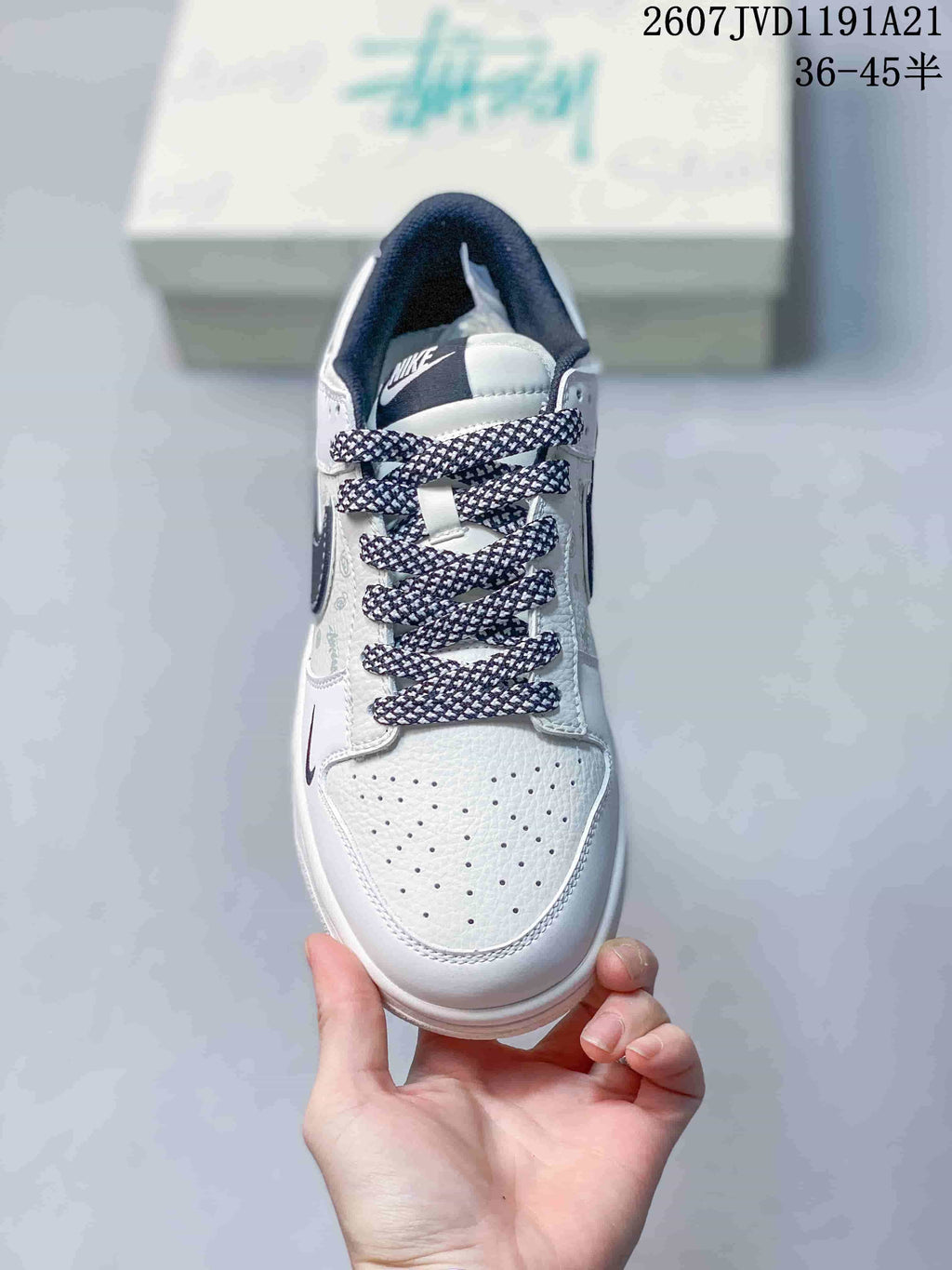 Top view of the sneaker showing the perforated white toe box, patterned laces, and dark tongue label.