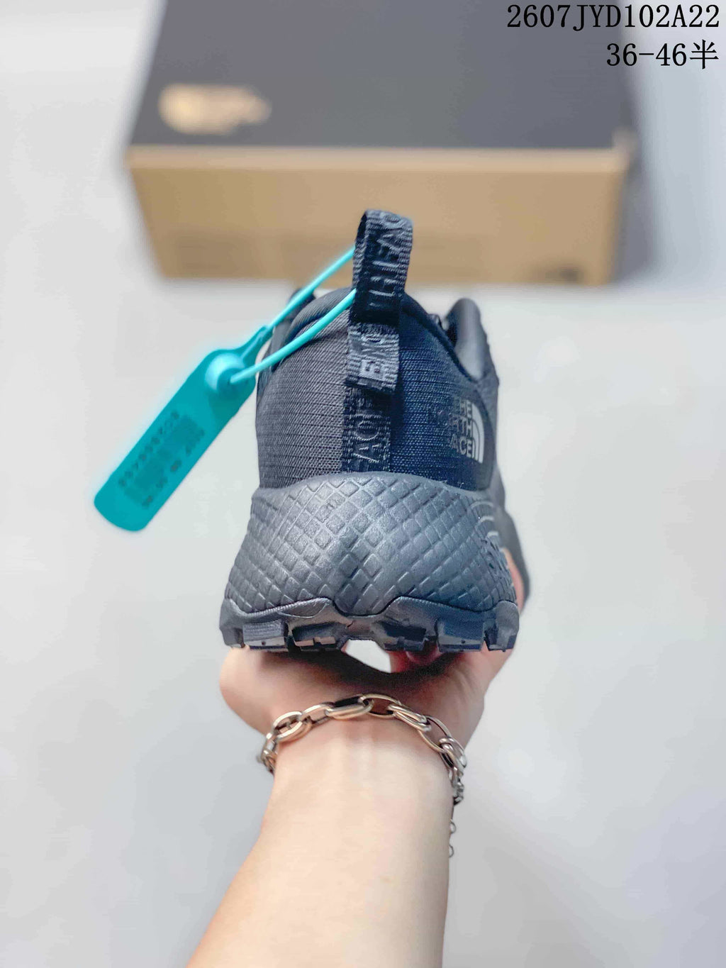 Rear view of the dark gray sneaker showing the padded heel area and outsole edge.