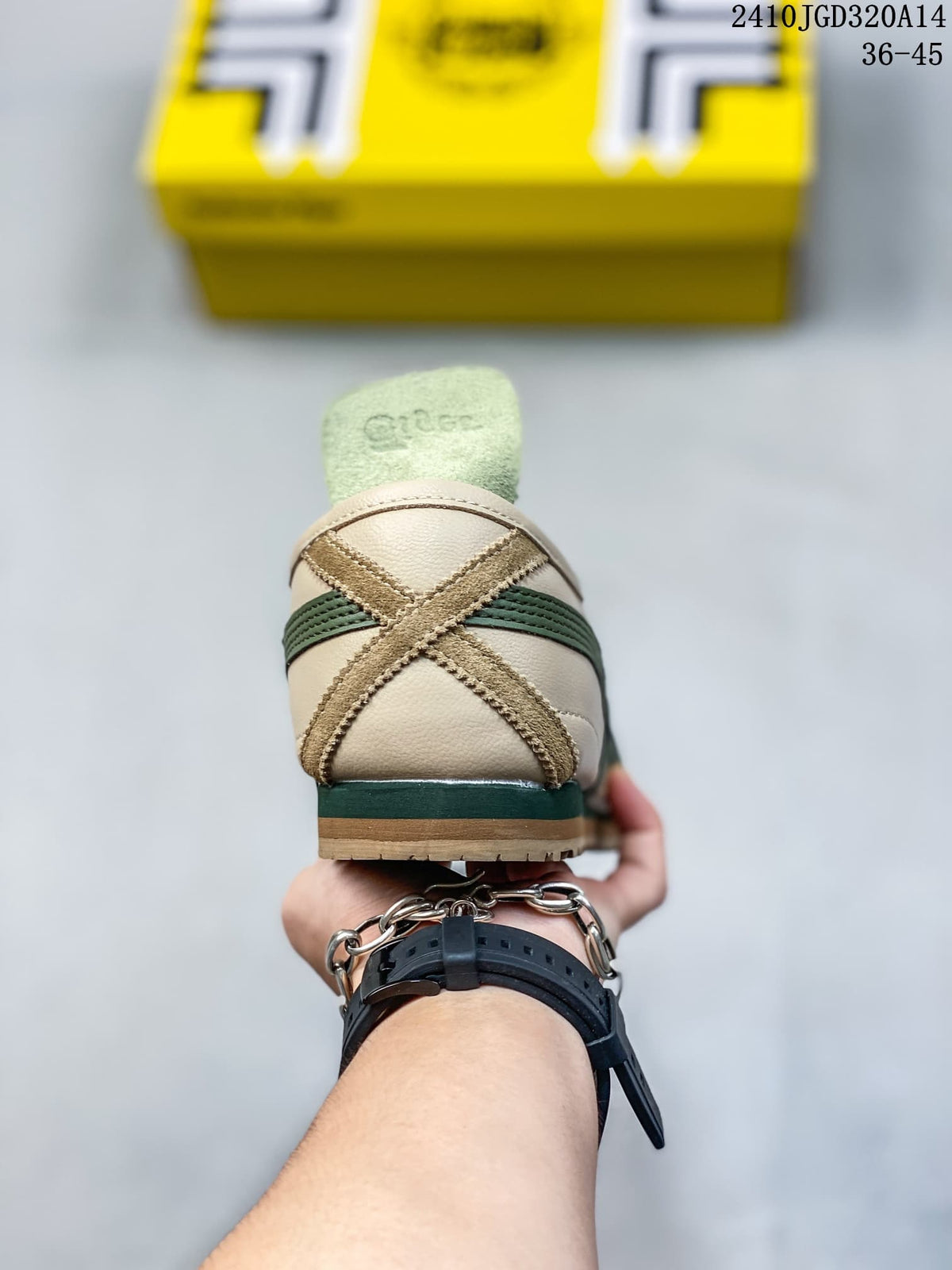 Rear view of the sneaker showing the crossed heel overlay, green stripe detail and padded collar.
