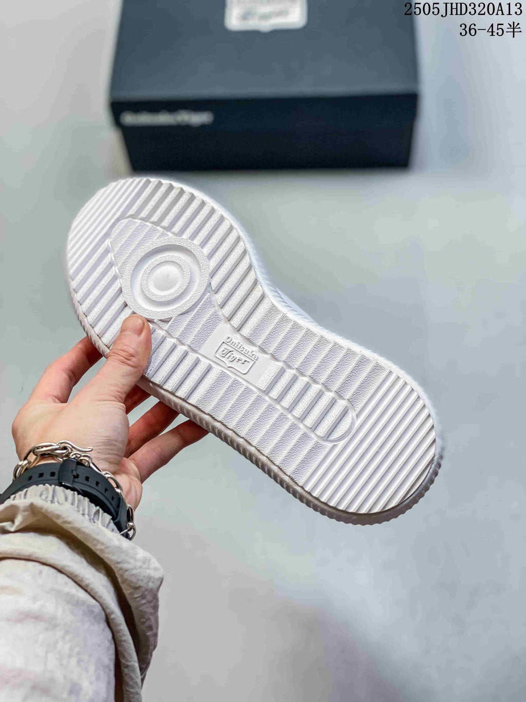 Underside view showing the ridged white sole of an Onitsuka Tiger Delecity sneaker
