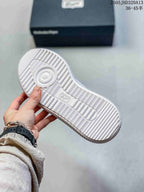 Underside view showing the ridged white sole of an Onitsuka Tiger Delecity sneaker