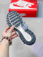 Bottom view of a Nike P-6000 sneaker showing the segmented black, gray, and white rubber outsole.