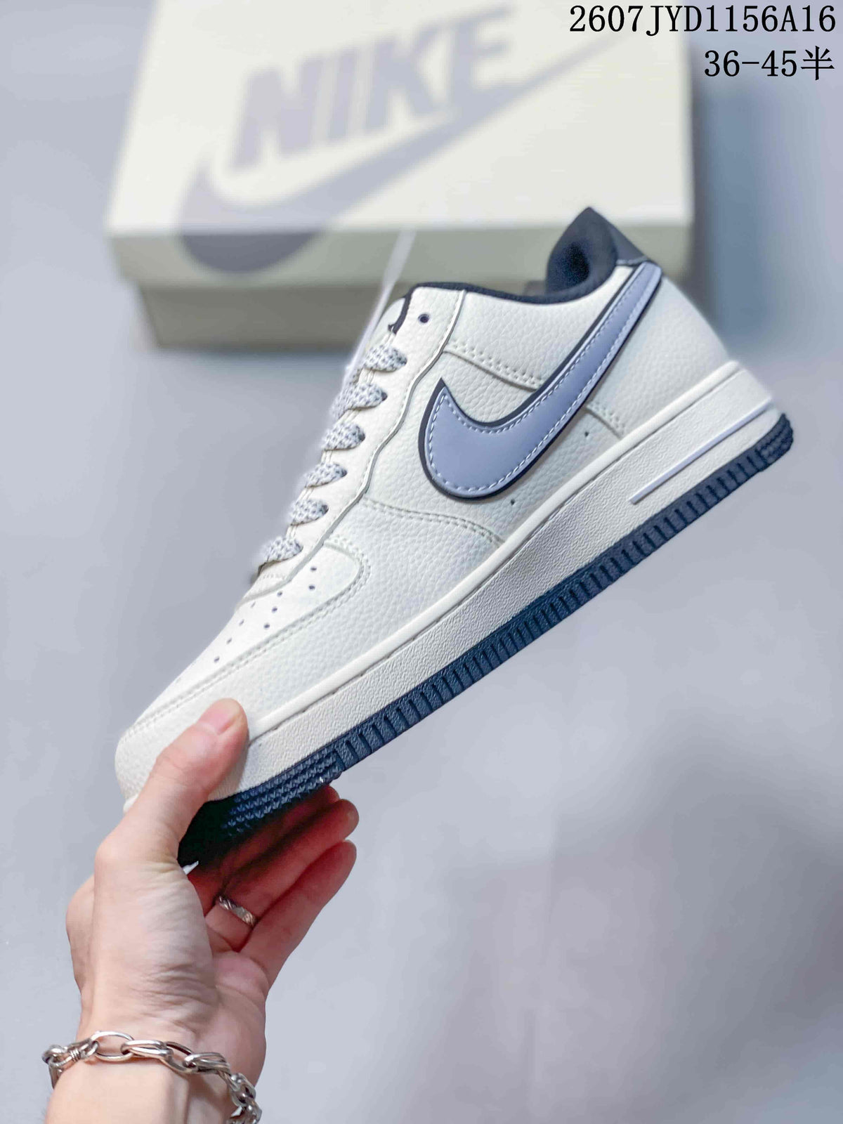 Side profile of the low-top sneaker showing the grey Swoosh, layered white panels and dark outsole.