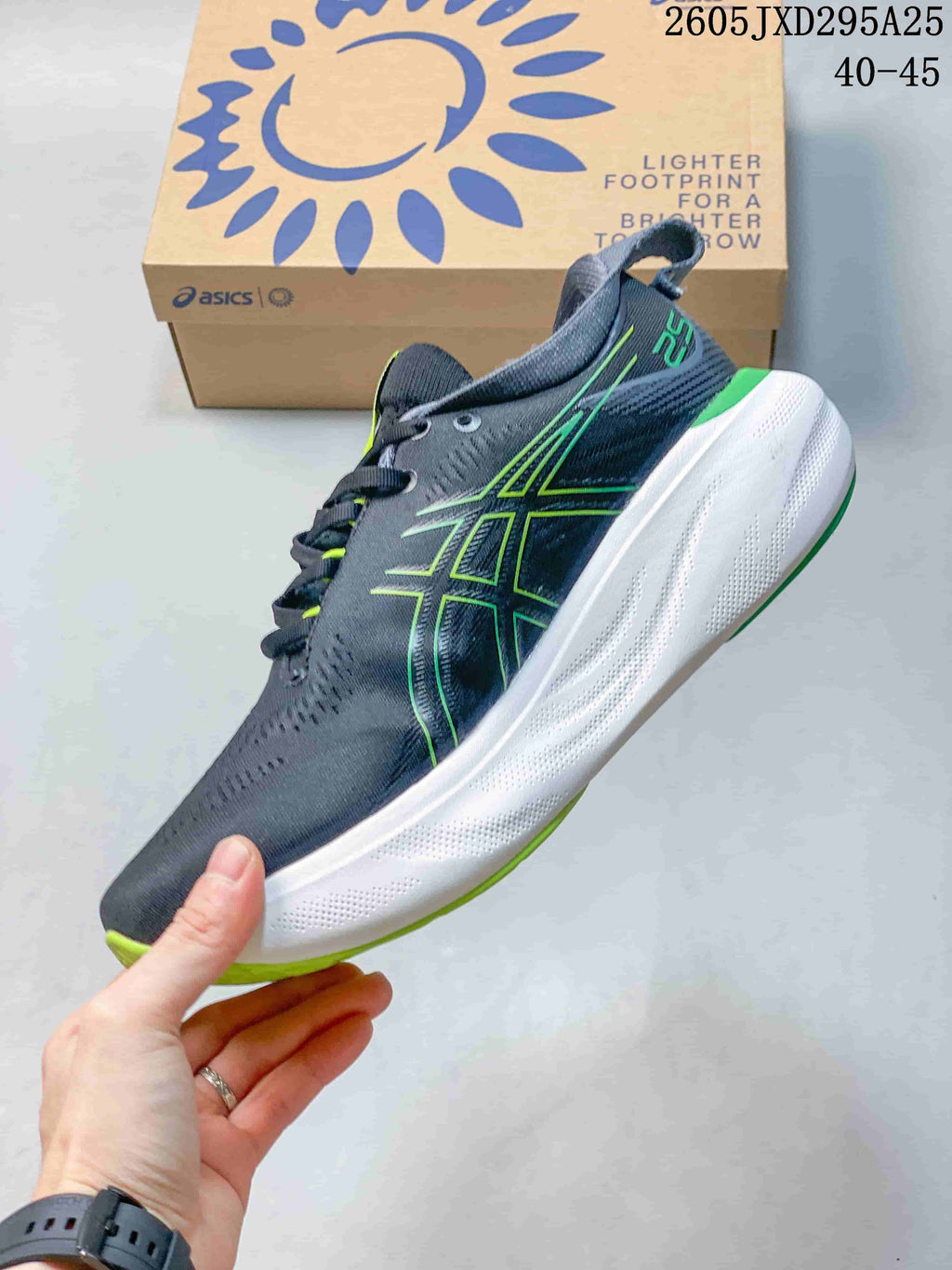 Side view of the dark gray shoe with lime green ASICS detailing and a white midsole
