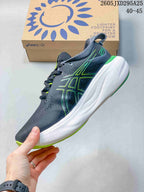 Side view of the dark gray shoe with lime green ASICS detailing and a white midsole