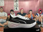 Side profile of a black and white basketball shoe with a red accent