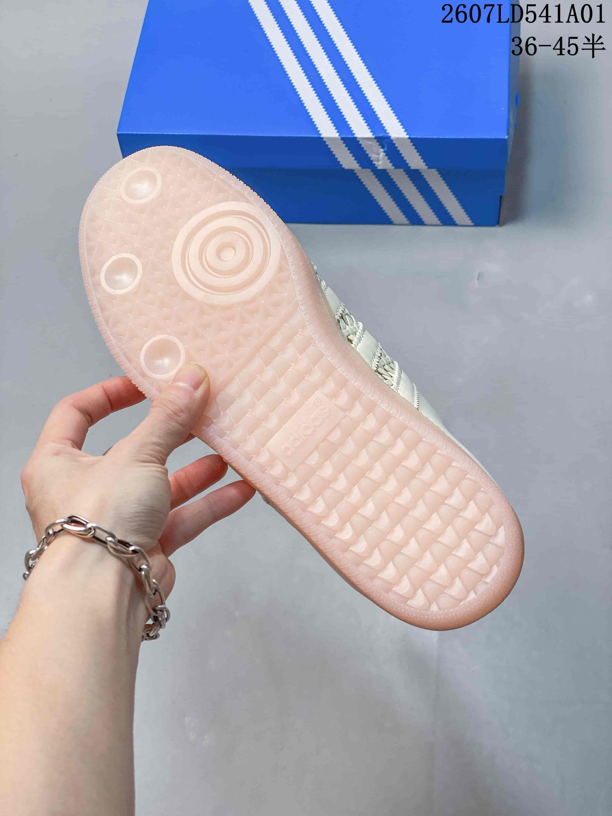 Underside of the sneaker showing a pale pink-looking outsole with textured tread.