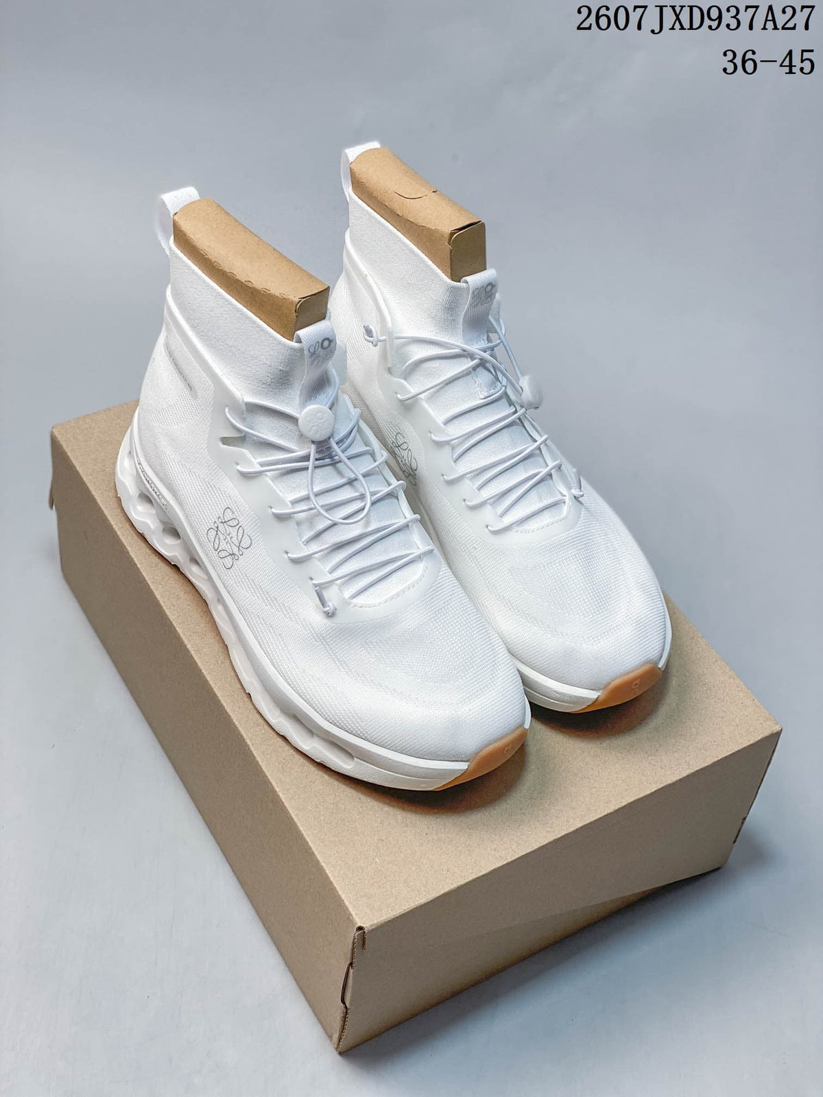 Pair of white Loewe x On Cloudtilt high-top sneakers displayed on a box, with the code 2607JXD937A27 and size range 36–45 visible above.