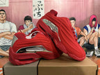Red sneakers displayed from side and top angles, showing the tread and silver-toned details.