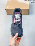 Top view showing the lace-up design and pink accents on a charcoal running shoe.