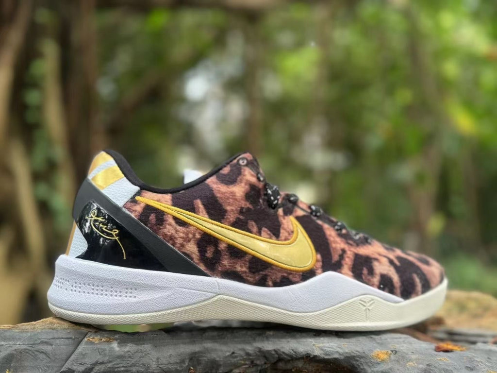 Side view of a leopard-print Nike Kobe 8 shoe with a gold Swoosh and white midsole